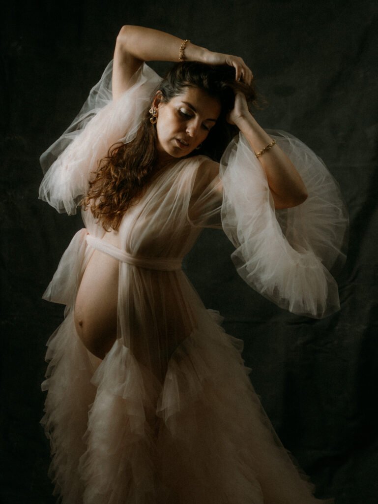 Maryam in moody studio lighting during a maternity portrait shoot in Hamilton