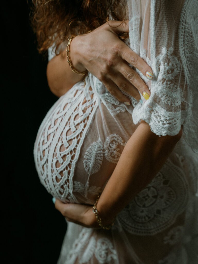 Maryam in moody studio lighting during a maternity portrait shoot in Hamilton