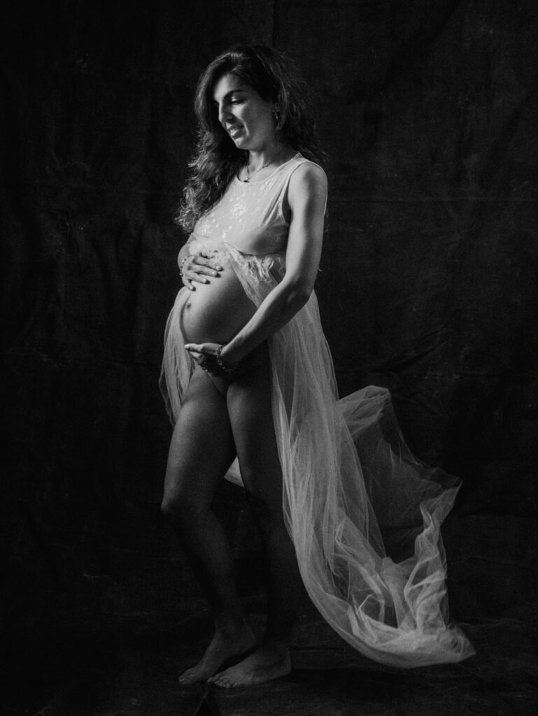 Maryam in moody studio lighting during a maternity portrait shoot in Hamilton