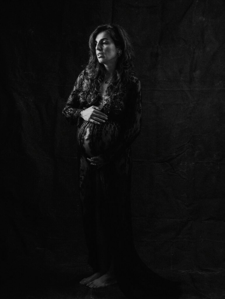 Maryam in moody studio lighting during a maternity portrait shoot in Hamilton