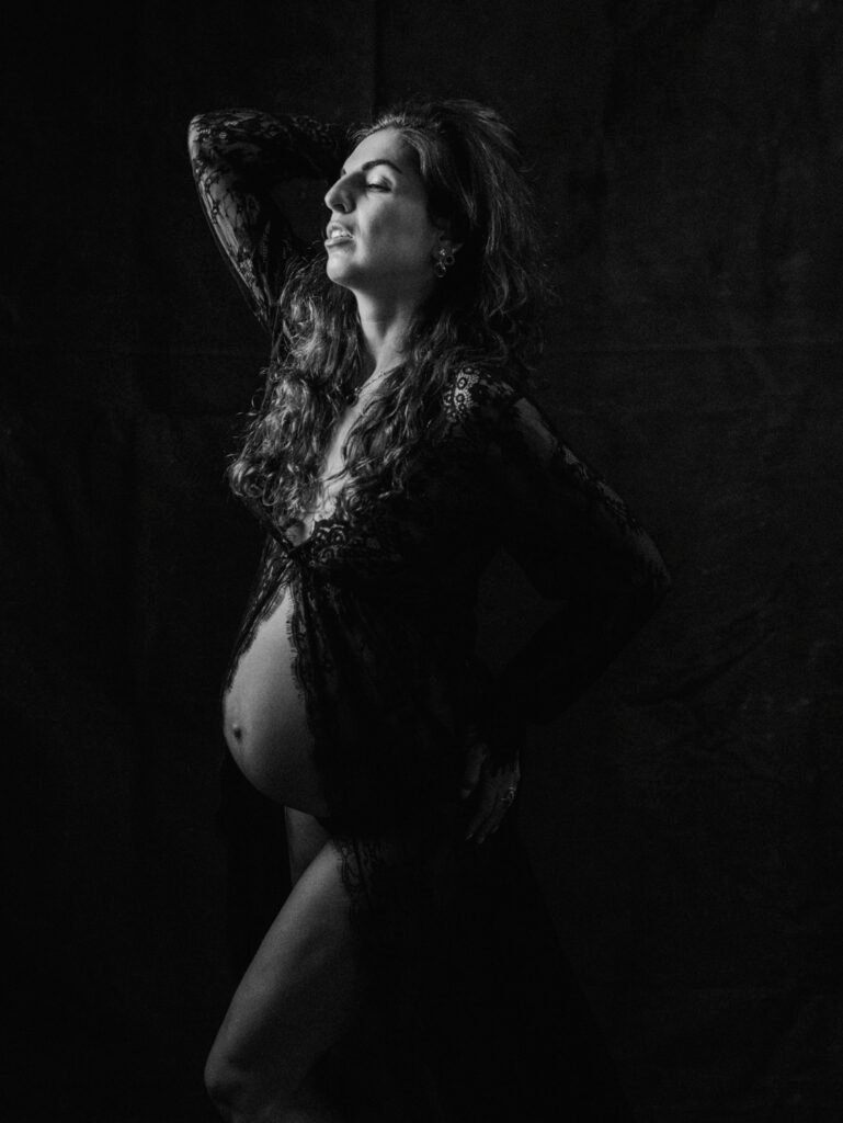 Maryam in moody studio lighting during a maternity portrait shoot in Hamilton