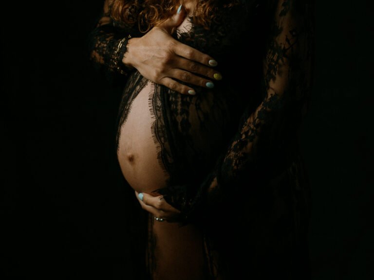 Maryam in moody studio lighting during a maternity portrait shoot in Hamilton