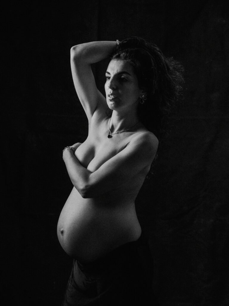 Maryam in moody studio lighting during a maternity portrait shoot in Hamilton