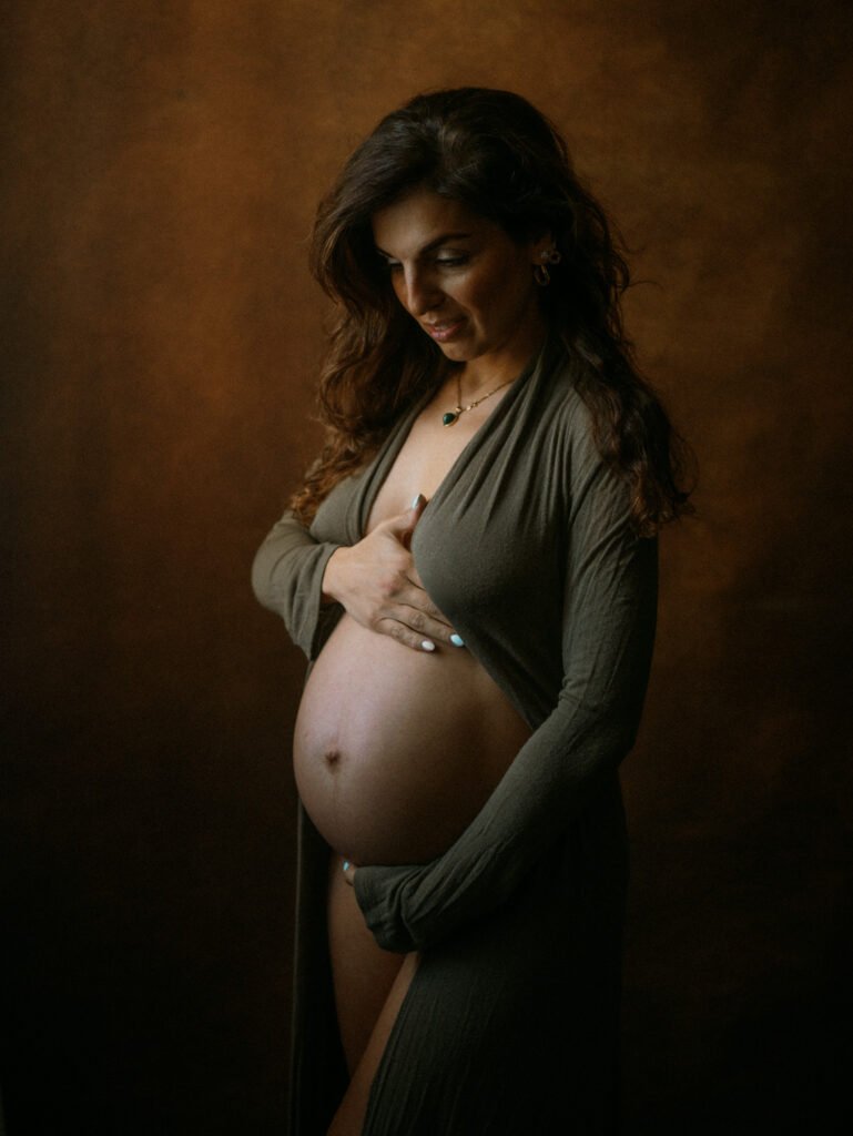 Maryam in moody studio lighting during a maternity portrait shoot in Hamilton