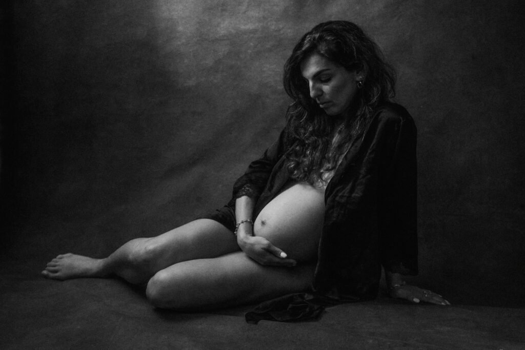 Maryam in moody studio lighting during a maternity portrait shoot in Hamilton