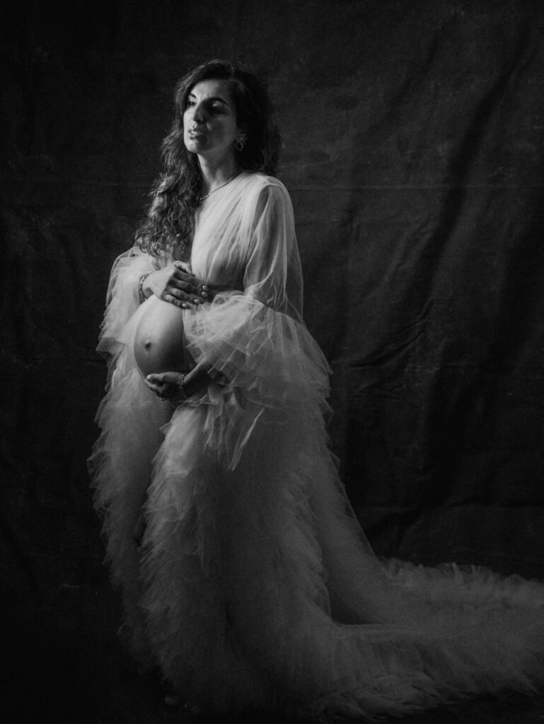Maryam in moody studio lighting during a maternity portrait shoot in Hamilton